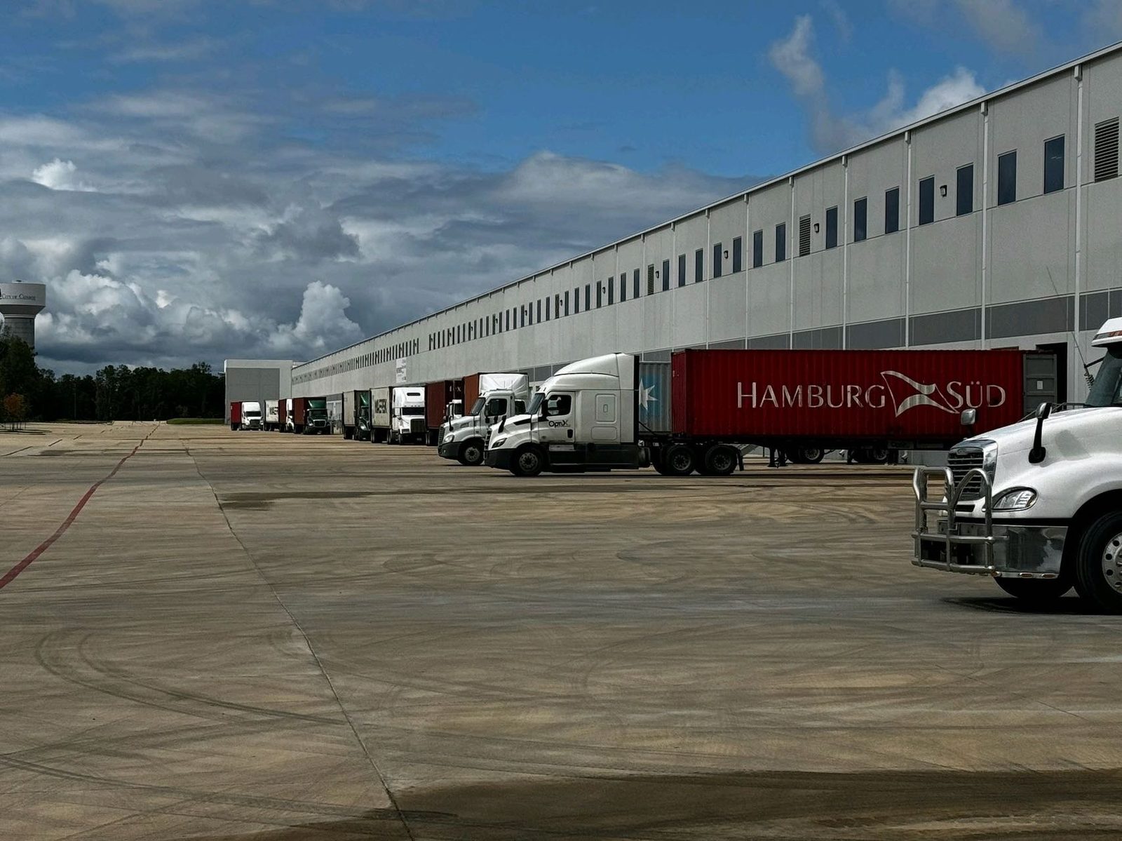 Trucks and shipping containers staged at our warehouse loading docks