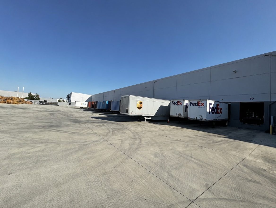 Cross-border logistics warehouse with stacked pallets and forklifts